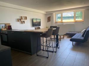 a kitchen with a table and chairs in a room at Le clos des Pommiers Fuji in Uffholtz