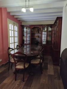 a dining room with a wooden table and chairs at Casa Hormaza in Chiclana de la Frontera +7 photos