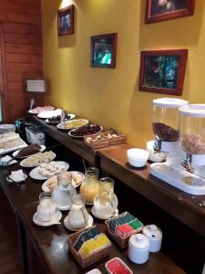 a buffet line with different types of food and desserts at Selva de Laurel in Puerto Iguazú