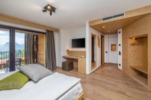 a bedroom with a bed and a large window at Miravalle in San Lorenzo in Banale