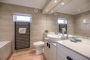 a bathroom with a sink and a toilet and a tub at Briargate, Aldeburgh in Aldeburgh +23 photos