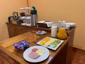 Hostal Qachi Chentura في سان بيدرو دي أتاكاما: طاولة عليها أطباق من المواد الغذائية والمشروبات