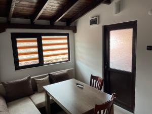 a living room with a table and a couch at Apart Uzunov-3 in Hisarya