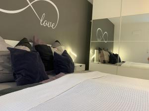 a bedroom with a bed with pillows and a mirror at Infinity Two in Waldbrunn