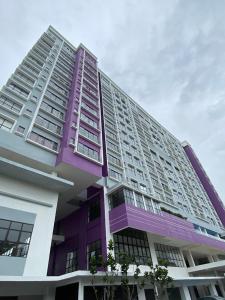 a large building with purple and white at TheSevenBahrin Homestay in Seri Kembangan