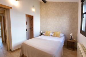a bedroom with a white bed with two pillows at Cuencaloft El Patio de Enrique in Cuenca