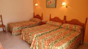 a hotel room with two beds in a room at Hostal Italia in Fuengirola