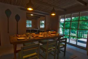 a dining room with a large wooden table and chairs at Casa Capirona 1 - Laguna Azul in Tarapoto