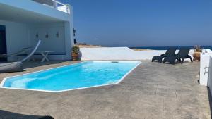The swimming pool at or close to NV seafront villa Aegina 1