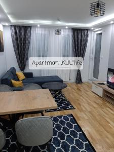 a living room with a couch and a table at Apartman,,KUL''life in Lukavica