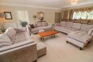 a large living room with couches and a coffee table at Bodmin Country House in Bodmin