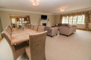 a large living room with a wooden table and chairs at Bodmin Country House in Bodmin