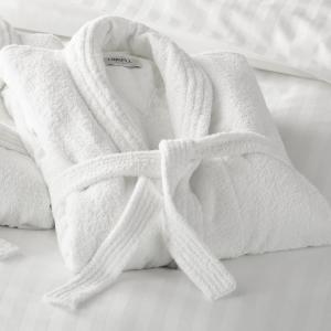 a white towel sitting on top of a bed at Ranmore Rise Retreat in the Surrey Hills in Dorking