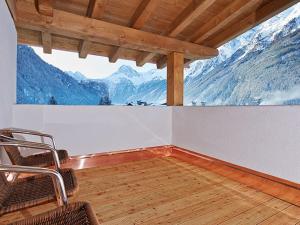 a room with chairs and a view of mountains at Appartement Alpenzauber in Längenfeld