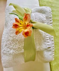 a vase filled with flowers on top of a towel at Ranmore Rise Retreat in the Surrey Hills in Dorking
