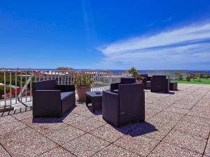 a group of chairs sitting on top of a roof at Residence Laura in Bordighera