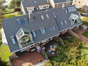 an aerial view of a house with a roof at Haus-am-Deich in Wittdün