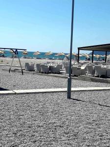 a group of chairs and a pole on a beach at Апартаменты Ирина М in Bar