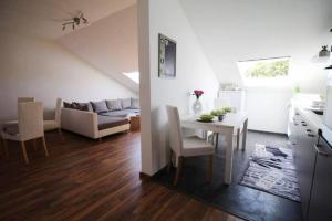 a kitchen and living room with a table and a couch at Neuberg Hanau Frankfurt in Neuberg