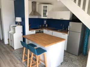 a kitchen with a wooden counter and a refrigerator at Kerguido in Ile aux Moines