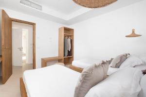 a bedroom with two beds and a closet at Maya Beach Resort in Massa Lubrense