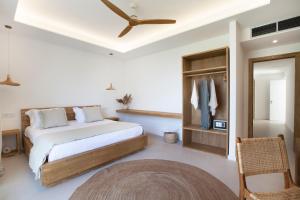 a bedroom with a bed and a ceiling fan at Maya Beach Resort in Massa Lubrense