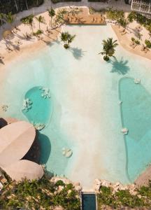 an overhead view of a swimming pool in a resort at Impression Moxché by Secrets - Adults Only in Playa del Carmen