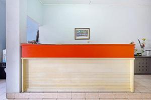 an orange and white counter in a room at Super OYO 91350 Garden Hostel in Bandung