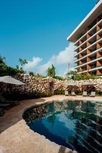 a swimming pool in front of a building at Impression Moxché by Secrets - Adults Only in Playa del Carmen