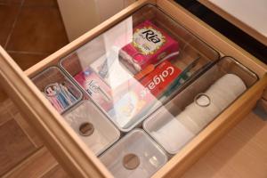 a drawer in a cabinet with toilet paper and other items at Chalupa Abecha in Dolní Poustevna
