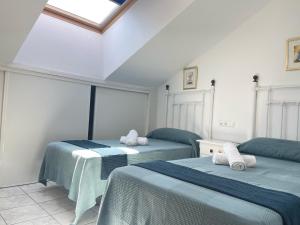 Postel nebo postele na pokoji v ubytování Hotel Al-Andalus