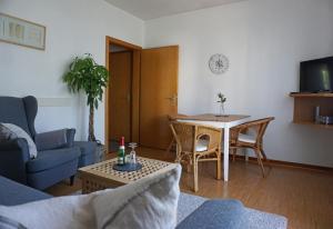 a living room with a couch and a table at Ferienwohnung Wiesengrund in Bad Endbach