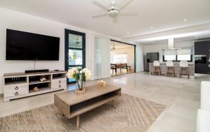 a living room with a television and a table at Stella Aparthotel, Las Terrenas in Las Terrenas
