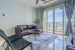 a living room with a couch and a table at Cozy 3-bedroom condo with pool 6 pax - Semarak in Kuala Lumpur