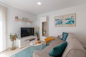 un soggiorno con divano e TV di BRISA C, Apartamento en El Médano a El Médano