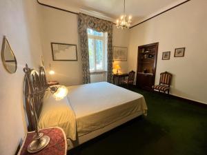 a bedroom with a bed and a table and chairs at Resort Villa San Luca CITR8031 in Imperia +27 photos