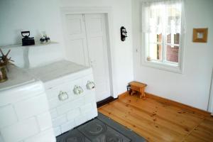 a kitchen with a white stove and a window at Chatka na Roztoczu in Bondyrz