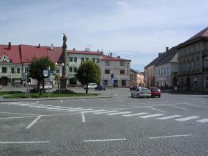 an empty street in a town with cars on the road at Pension BRILLIA in Police nad Metují
