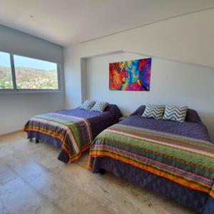En eller flere senge i et værelse på Apartamento Frente al Mar en Acapulco