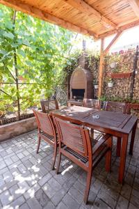 a wooden table and chairs on a patio at Casa Maria in Constanţa