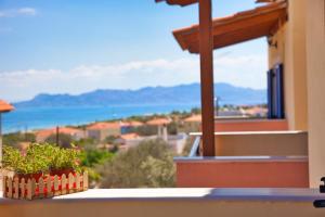 a balcony of a house with a view of the ocean at STUDIOS ATHENA in Megalochori