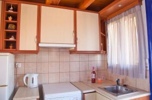a kitchen with a sink and a counter top at STUDIOS ATHENA in Megalochori +18 photos