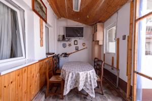 a room with a table and chairs and a window at Casa Maria in Constanţa
