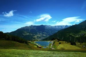 a view of a mountain valley with a lake at ... mein romantisches Hotel Toalstock in Fiss