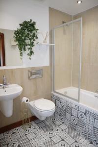 a bathroom with a toilet and a sink and a shower at The Kenway in Southend-on-Sea