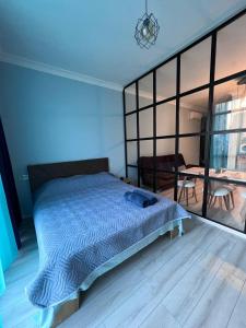 um quarto com uma cama grande e uma mesa em Apartment Merabi em Batumi