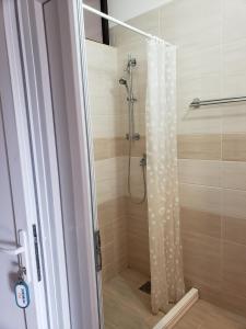 a shower with a shower curtain in a bathroom at Apartments Petricevic in Sutomore +91 photos