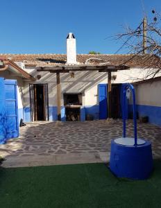 uma casa com um edifício azul e branco em Tierra y Agua em Fernancaballero