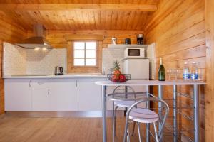 a kitchen with a table with chairs and a refrigerator at La Cabañita de Javi in Tuineje +12 photos