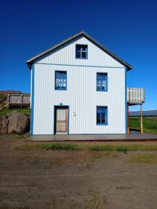 a white building with a door on the side of it at Setberg in Egilsstadir